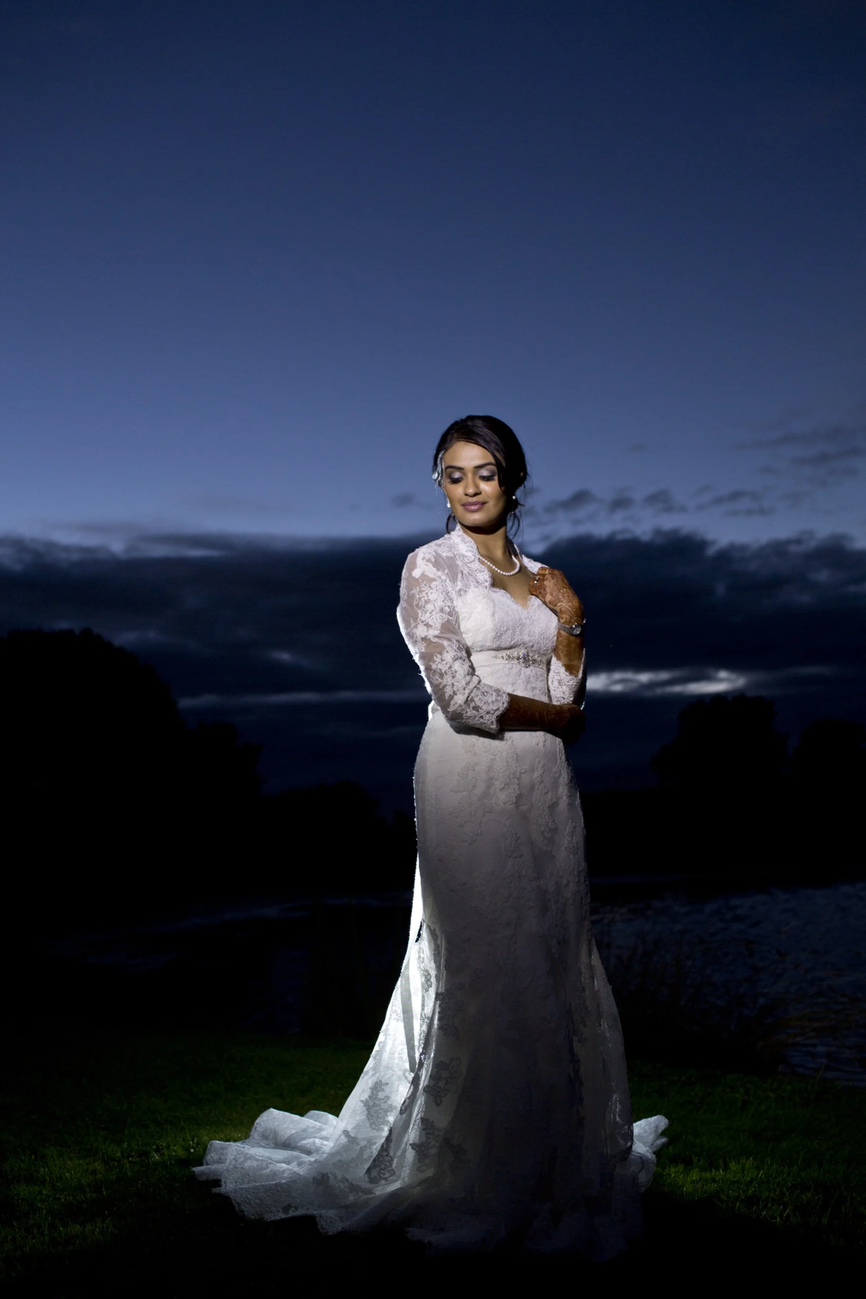 Bride at blue hour with city lights behind her
