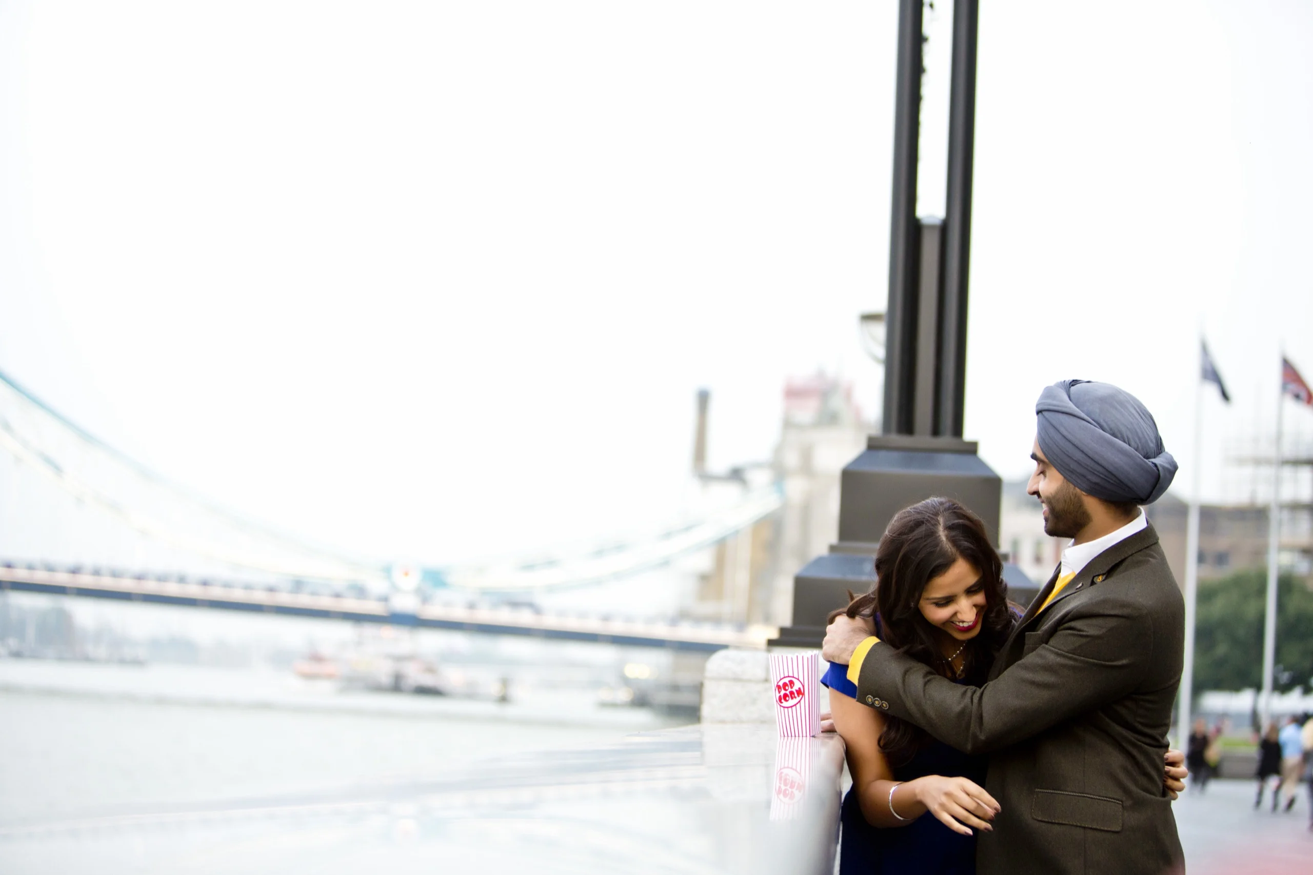 Couple on a rooftop with the London skyline behind them