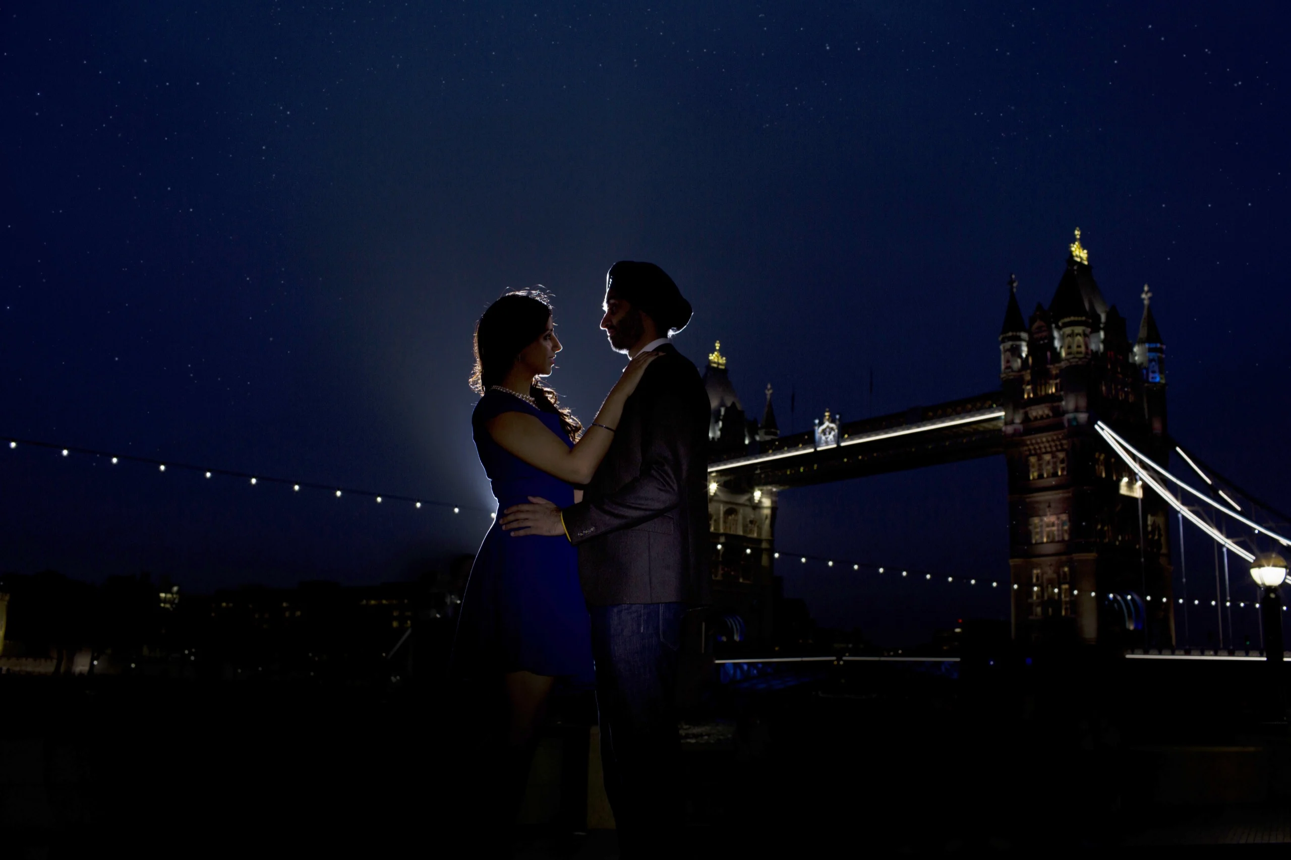 Couple embracing at night by the water