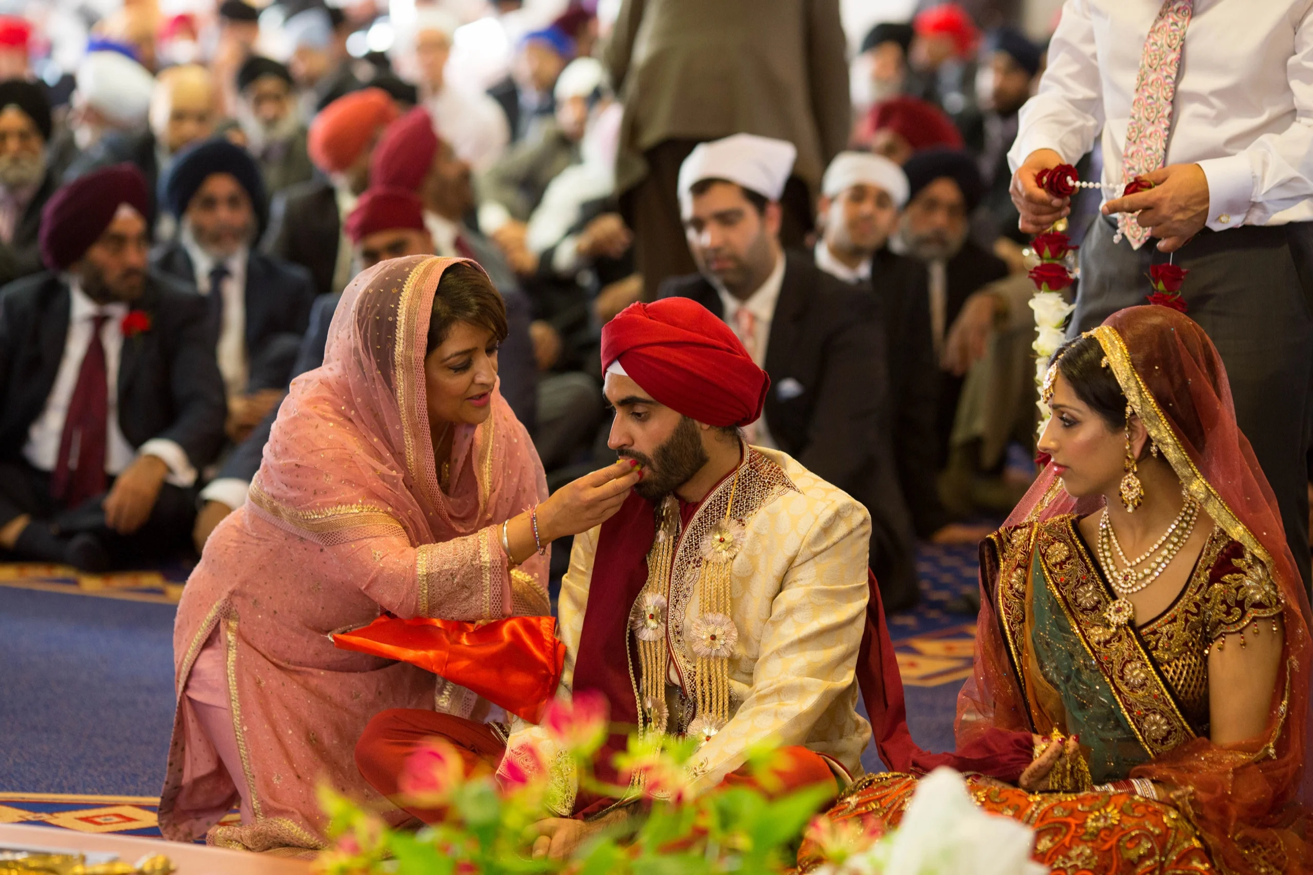 Sikh wedding ceremony with family gathered around the couple